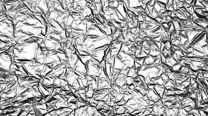 Crumpled foil sheet background texture , silver aluminum foil as background for design