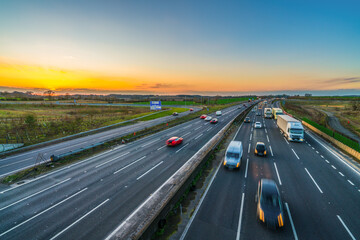 Colorful sunset at M1 motorway near Flitwick junction with blurry cars in United Kingdom