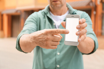 Man using smart phone outdoors