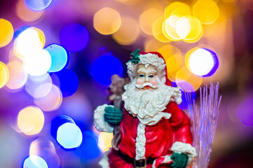 Papa Noel on the background of colorful lights. Christmas decor.