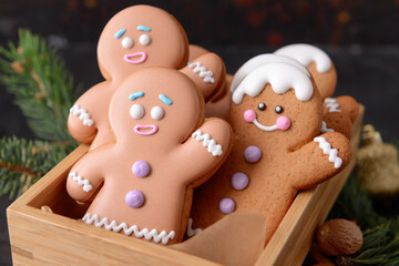 Box with tasty gingerbread cookies on table, closeup