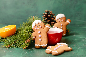 Christmas composition with gingerbread cookies and cup of tea on color background