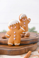 Tasty gingerbread cookies on white wooden table