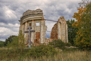 Fototapeta na wymiar Ruins of the ancient Trinity Church in the village of Pyataya Gora on a cloudy September day. Leningrad region, Russia