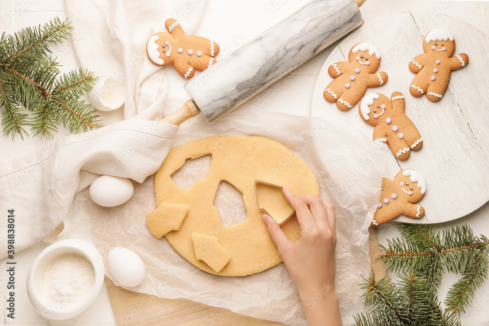 Wall mural Woman preparing tasty Christmas cookies at table