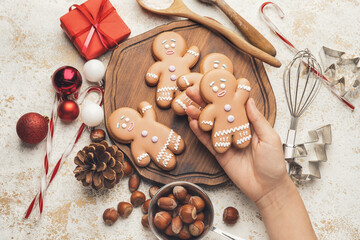 Woman holding tasty Christmas cookie