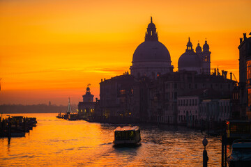 Fototapeta na wymiar Beautiful sunrise silhouette of Grand Canal and Basilica Santa Maria della Salute in Venice, Italy