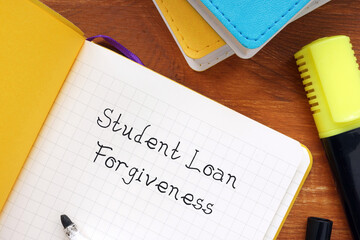 Financial concept meaning Student Loan Forgiveness with sign on the piece of paper.