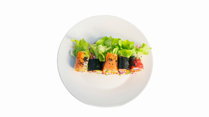 A picture of a salad rolled on a plate and a white