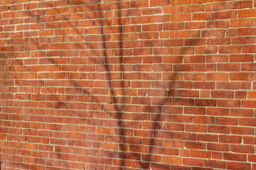 Full frame abstract texture background of a grungy and worn antique red clay brick wall with view...