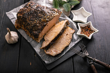 Sliced delicious homemade cold boiled pork with spices. Pork appetizer for Christmas table. Top view