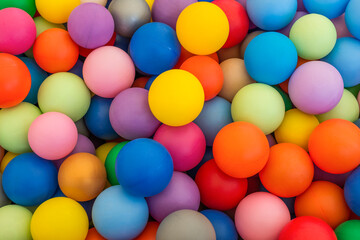 Full frame of multicolored plastic balls in the ball pit (ball crawl). Lots of colorful balls for...
