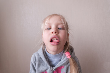 little blonde girl making faces