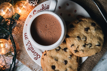Top view of chocolate mug with Christmas lights chip cookies - Christmas eve - Christmas content - Christmas traditions