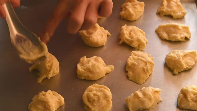 Homemade butter cookies, hand putting batter on tray preparing for baking