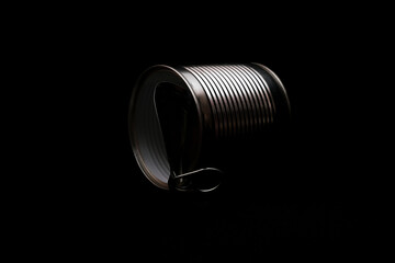 Open empty tin can on dark background
