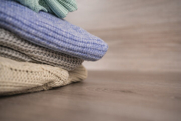 a stack of warm cozy woolen sweaters jersey jumpers for the winter