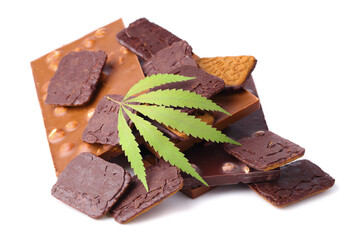 Bars of black and milk chocolate with cookies containing CBD cannabis and green hemp leaf on white isolated background. Chocolate with marijuana extract. Entertainment drug concept