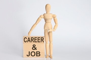 Wooden man shows with a hand text CAREER AND JOB concept on the wooden block