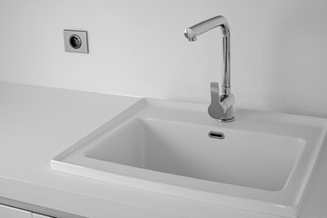 Modern bathroom interior with sink and chrome faucet. White color background