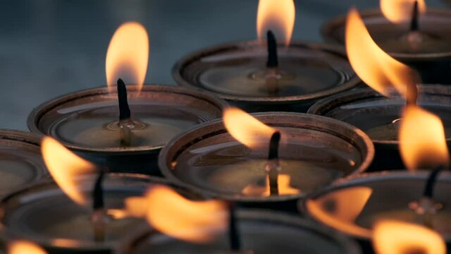 Flames of candles near the Boudhanath stupa in Kathmandu, Nepal.