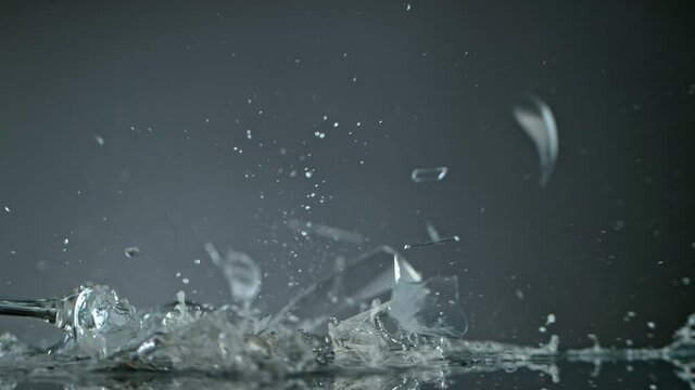 Breaking Glass with Champagne on Grey Background at 1000 fps.