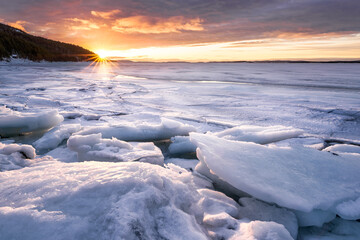 White Sea Gold. The shore of the White Sea in Kandalaksha Bay is covered with glaze-like ice after...
