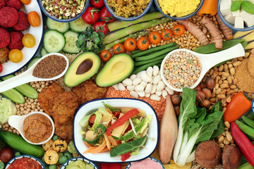 Fototapeta na wymiar Vegan food for a healthy immune boosting diet with legumes, vegetables, nuts, dips, grains, snacks & cereal products. Plant based health foods for ethical eating & a healthy planet. Flat lay.