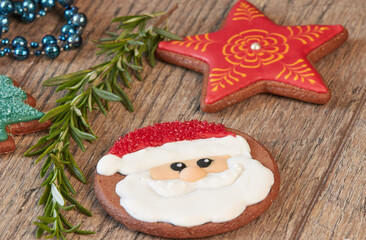 Painted Christmas gingerbread cookies on a wooden table.