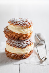Homemade and sweet cream puffs with powdered sugar