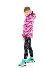 A little girl with headphones listening to music.