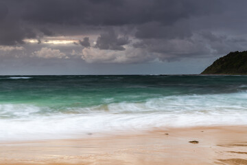Fototapeta na wymiar Moody morning bay seascape with rain clouds