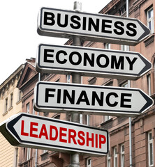 The road indicator on the arrows of which is written - business, economics, finance and LEADERSHIP