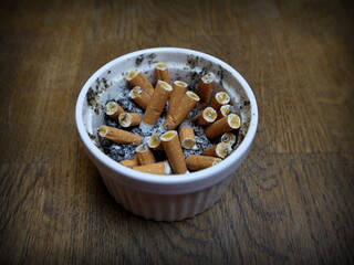 cigarette butts and ashes in a white cup. World No Tobacco Day