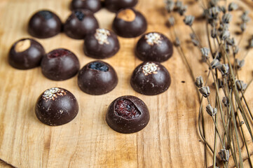 Round sweets stuffed with dark chocolate on a wooden tray