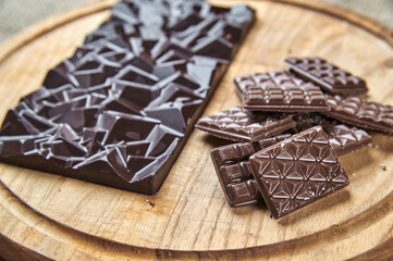 Bars of black and milk chocolate on a wooden tray