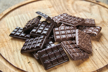 Bars of black and milk chocolate on a wooden tray
