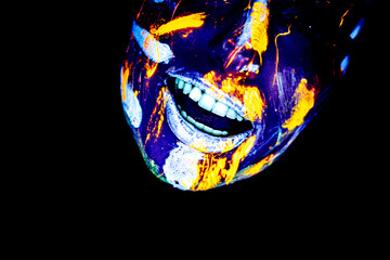 UV Ultra Violet portrait of a female face with an isolated subject and black background tilted head