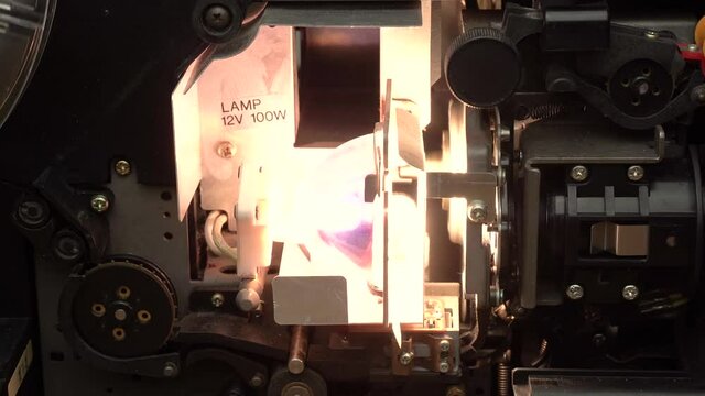 Super 8 cine film projector in operation. Close up shot of open internal mechanism