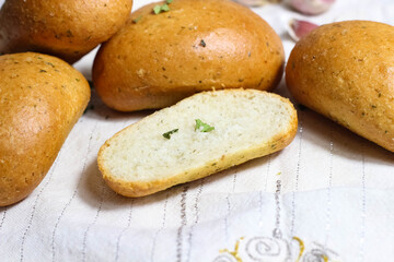 Fresh hot Garlic buns sprinkled with herbs. Selective shot.