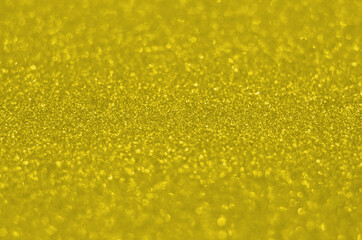 Illuminating Pantone Color Of The Year 2021. Abstract festive bokeh background with shining defocus sparkles. Blurred glitters shimmering dust macro close up, copy space for text logo