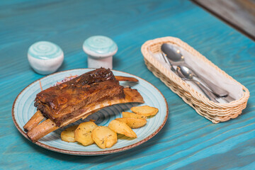 Delicious and hearty texas ribs with homemade potatoes and salad