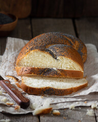 Poppy seed bun. Bread with poppy seeds on a wooden background. Homemade cakes with poppy seeds