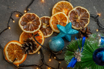 Yellow slices of dried orange and lemon on gray dark background Christmas composition. Top view, selective focus