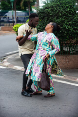 happy couple talking together in the street