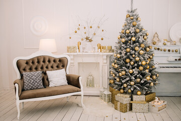 Big beautiful Christmas tree with gifts in a white decorated hall for the New Year. Piano. 