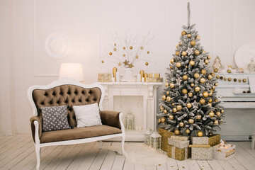 Big beautiful Christmas tree with gifts in a white decorated hall for the New Year. Piano. 