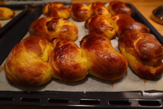 Close up on one plate of home made Swedish saffron buns. Not traditional shapes, but very tasty. Stockholm, Sweden.