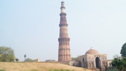Five level victory tower Minaret of Qutb in Delhi, India.It is made of red sandstone, wide at the base and narrowing gradually at the top. There are inscriptions  in Arabic  on it.