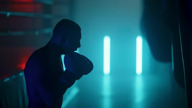 Boxer in the boxing gym. Bandages his hands. Sparring in the ring. Boxer jumping rope. Exercise with ropes. Round one. Fog in the ring. Zetsky sport. Beautiful backlight. World boxing champion.
